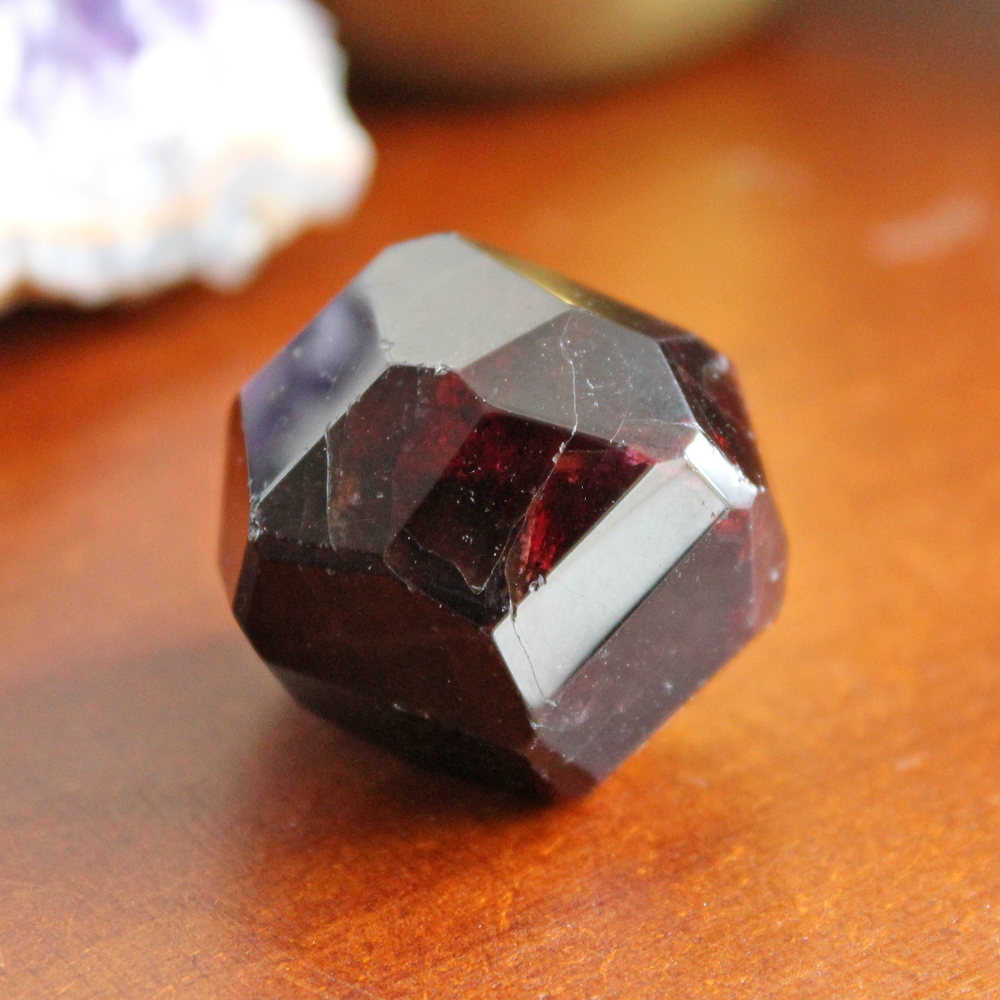 This is a polished but naturally faceted Almandine Garnet crystal