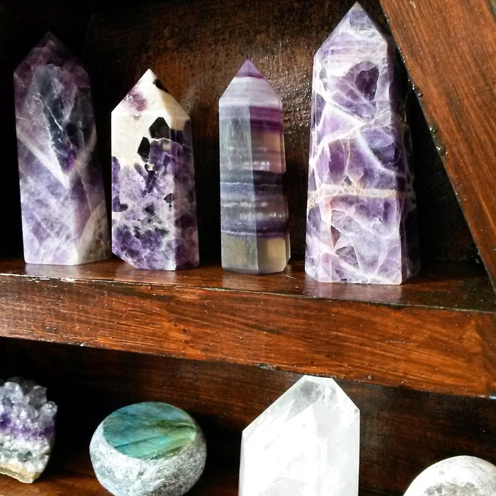 Crystals and crystal points on a wooden shelf