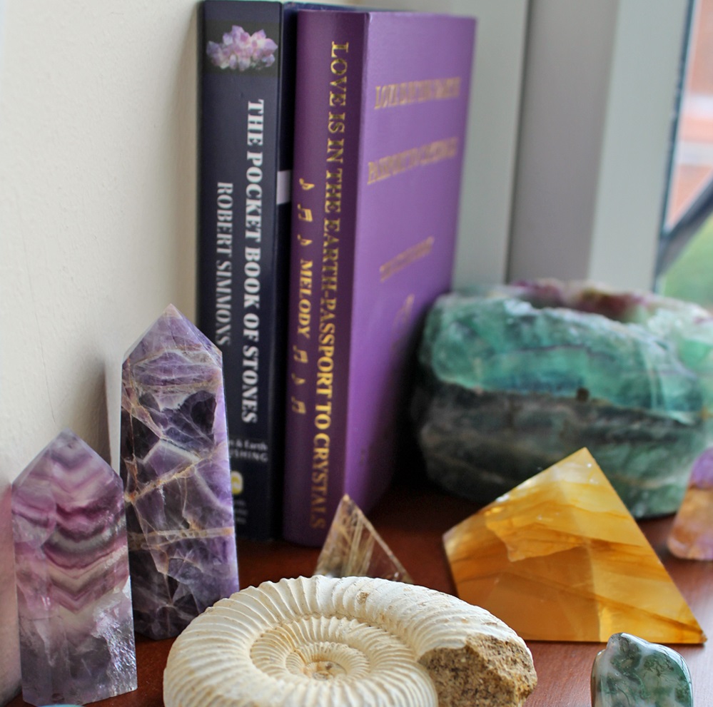 Books, crystals, candle holder, pyramid and fossil