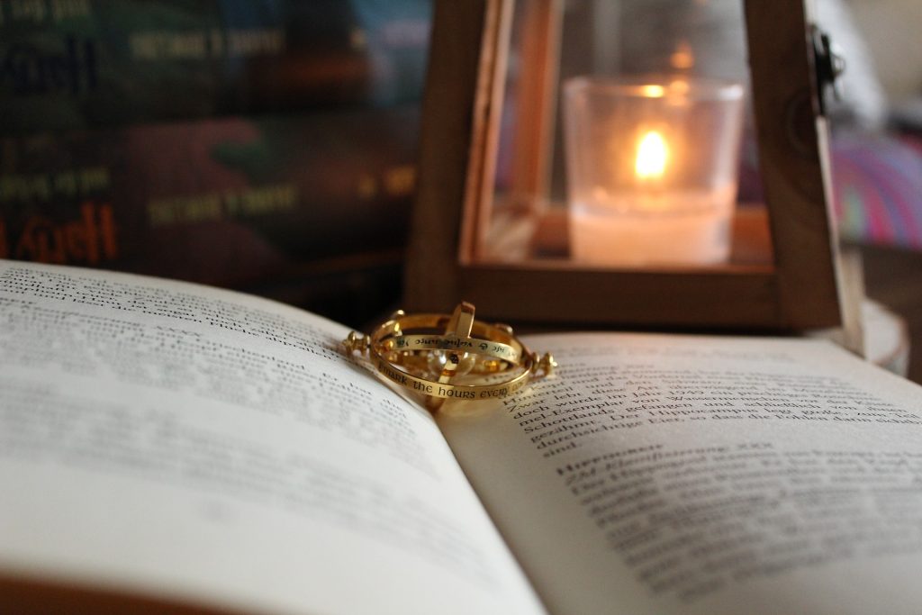 The time turner necklace on a book with a lantern