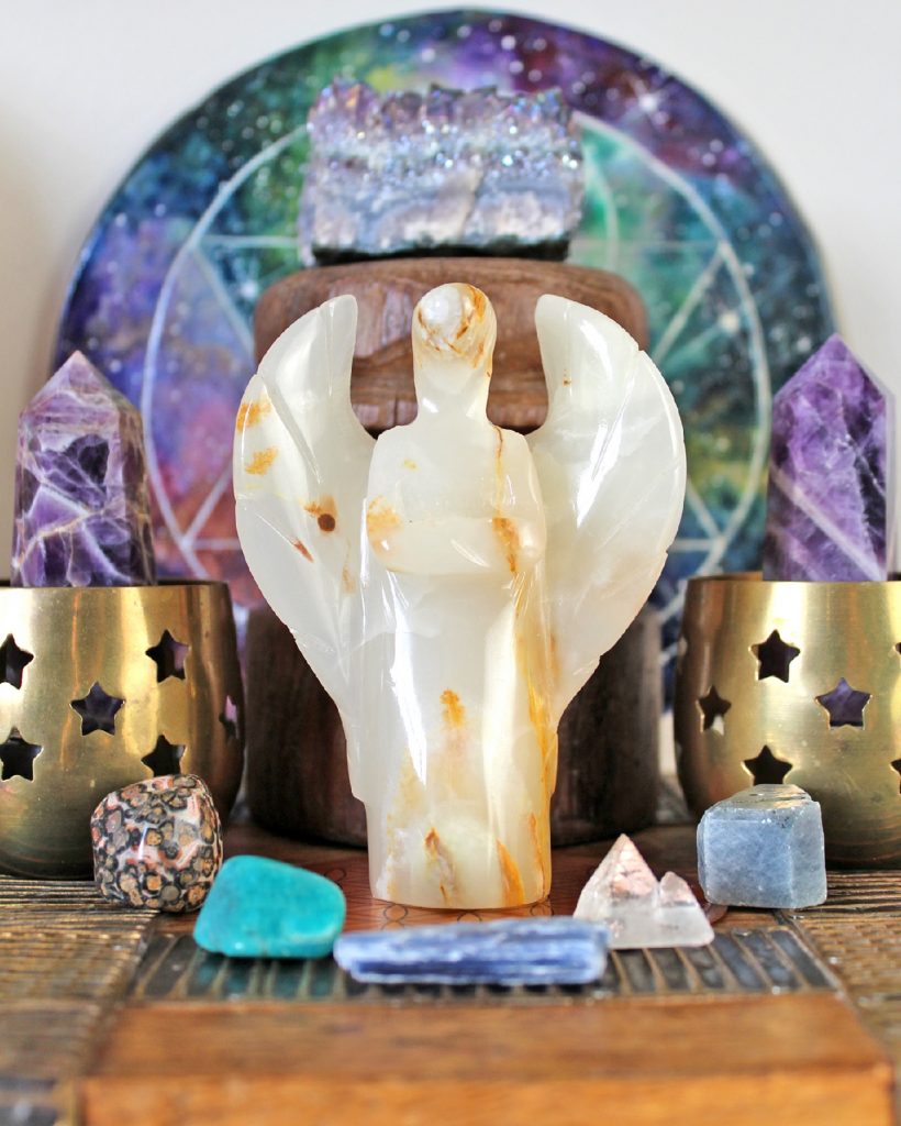 Crystal angel altar with onyx angel, brass candle holders and different crystals