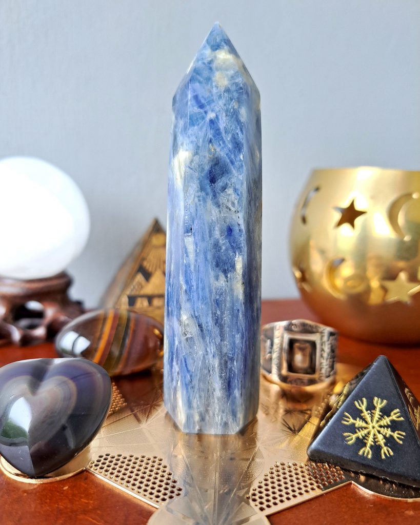 Blue kyanite tower with various protection crystals around it used to shield from negative people